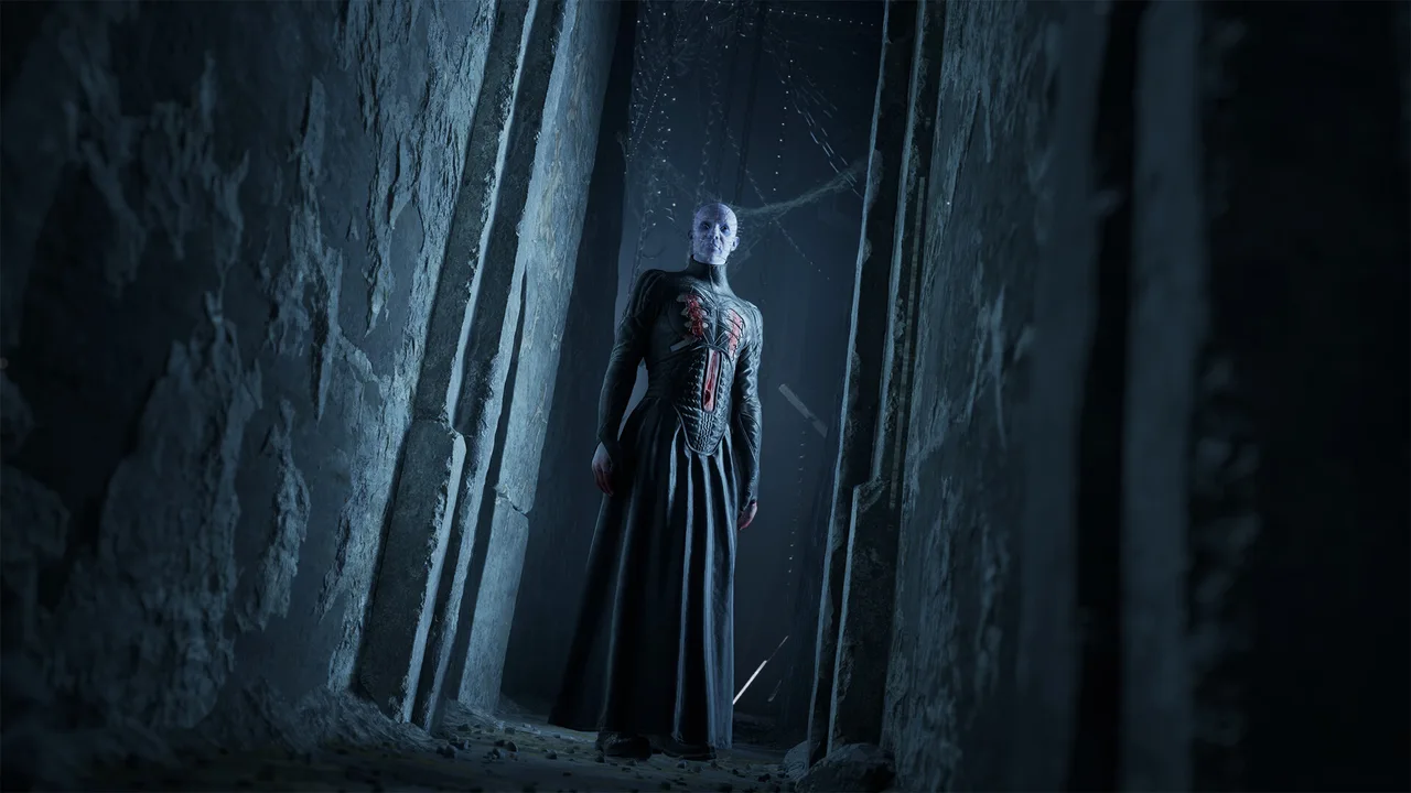Pinhead standing between towering dark stone pillars
